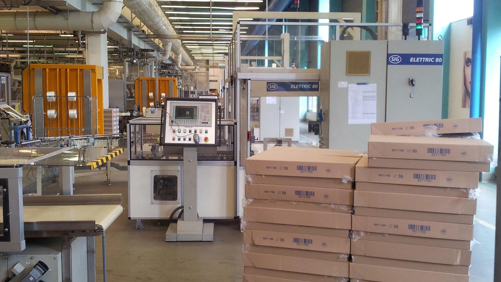 Cardboard boxes and two Bramidan balers in Cosmeva production area